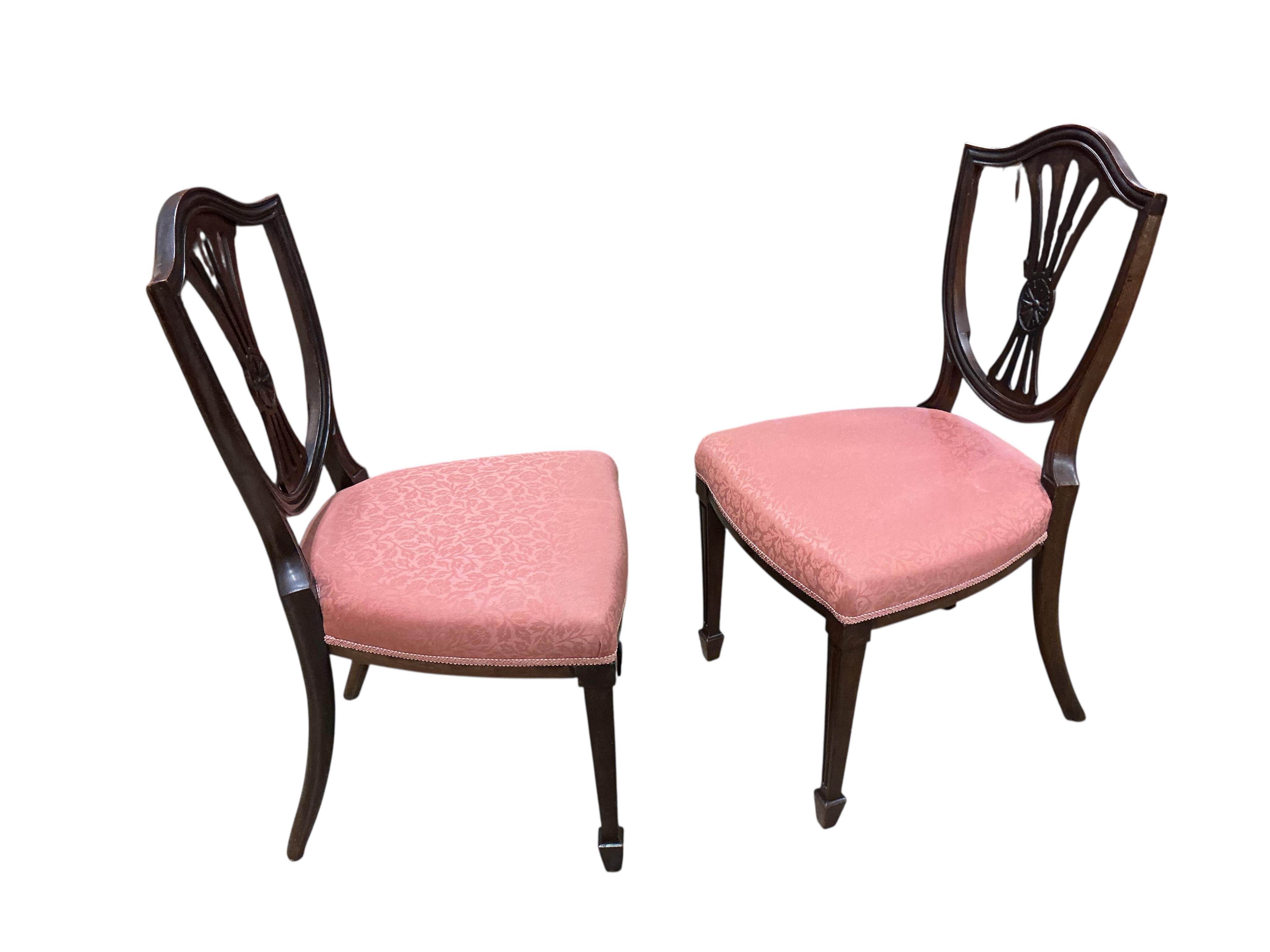 A set of fourteen early 20th century mahogany Sheraton style mahogany dining chairs, two with arms